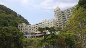 a large building on the side of a mountain at 焼津グランドホテル 