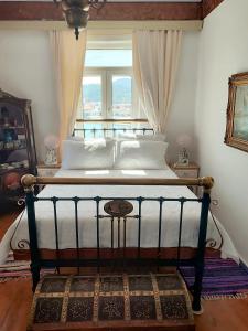 a bed in a bedroom with a window at Kokkari Traditional House in Kokkari