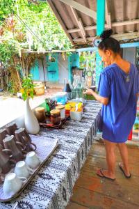 a woman standing in front of a table at The Mermaid House in Ko Kood