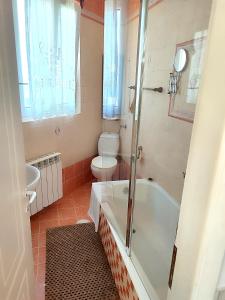 a bathroom with a tub and a toilet and a sink at Kokkari Traditional House in Kokkari