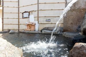 a water fountain in front of a building at Shosenkaku in Nagano