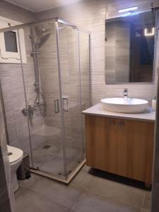a bathroom with a shower and a sink and a toilet at Sweet cottage in Chanioporta in Heraklio Town +21 photos