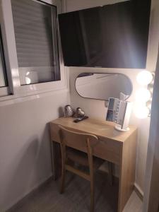 a desk with a mirror and a lamp on it at Sweet cottage in Chanioporta in Heraklio Town