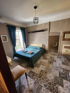 a bedroom with a blue bed and a brick wall at La Pennichella Sorrentina Relais in Meta