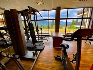 a gym with several tread machines and a large window at Panorama View-Stoykite in Stoykite