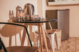 a table with a coffee maker on top of it at Namphung Phuket Boutique Resort in Rawai Beach