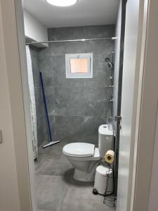 a small bathroom with a toilet and a window at Simply Elegant in Tel Aviv