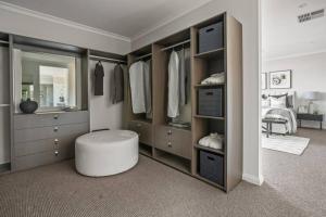 a bedroom with a large closet with a stool in it at Werribee Gem Luxe Home Family Getaway 6Bed Netflix in Werribee +45 photos