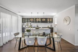 a dining room with a glass table and white chairs at Werribee Gem Luxe Home Family Getaway 6Bed Netflix in Werribee