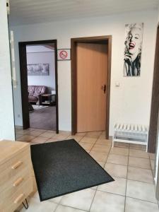 a living room with a door and a mirror at Haus Mohr - Ferienwohnung im Taunus in Weilmünster