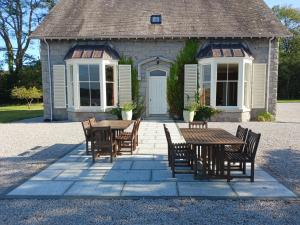 a table and chairs in front of a building at Auchenvhin - Rockcliffe in Dalbeattie