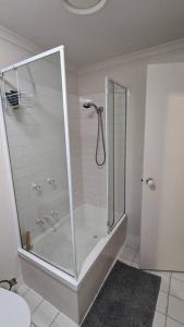 a shower with a glass door in a bathroom at 3 bedroom condo opposite casino. in Melbourne