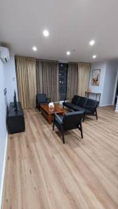 a living room with couches and a coffee table at 3 bedroom condo opposite casino. in Melbourne