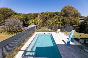 a swimming pool in the backyard of a house at Serendipity in Forster