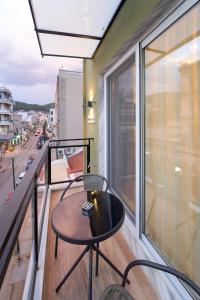 a balcony with a table and chairs on a balcony at XANTHI POLIS CITY CENTER with private parking in Xanthi