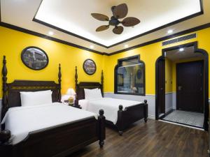 a bedroom with two beds and a ceiling fan at Charming beauty hotel in Da Nang