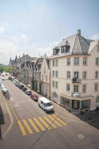 a white van parked on a city street with buildings at Modern 3-bedroom apartment in city centre in Basel