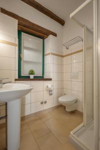 a bathroom with a sink and a toilet at Villas Orbani by Istarski Dvori in Sveti Lovreč Pazenatički