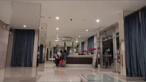 a lobby with people standing in a building at Educity 2 Bedroom by Marco H10 Wifi in Surabaya