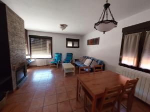 a living room with a couch and a table and chairs at La Atalaya de Villalba in Cuenca