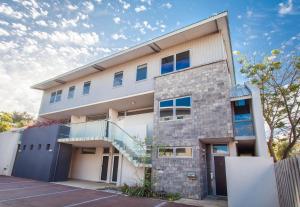 a large building with a staircase in front of it at Dunn Bay Apartment 6 in Dunsborough