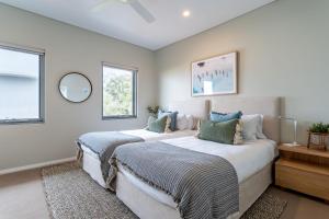two beds in a room with two windows at Dunn Bay Apartment 6 in Dunsborough