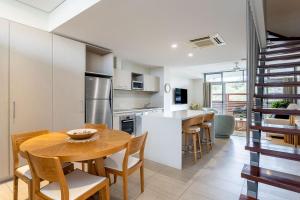 a kitchen and dining room with a table and chairs at Dunn Bay Apartment 6 in Dunsborough