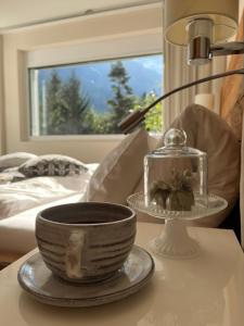 a table with a bowl and a lamp on a table at Luxuslodge - Zeit zum Leben in Annaberg im Lammertal