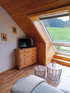 a living room with a large window in a tiny house at Ferienwohnung Brentenholz in Sankt Georgen im Schwarzwald