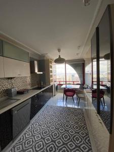 a kitchen with two red chairs and a table at The Most Luxurious Apartment-The Flat New York in Ankara