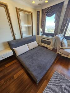 a large couch in a living room with a window at The Most Luxurious Apartment-The Flat New York in Ankara