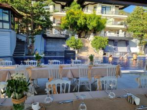 a table set up for a wedding in front of a pool at Villa Marine Hotel in Akyaka