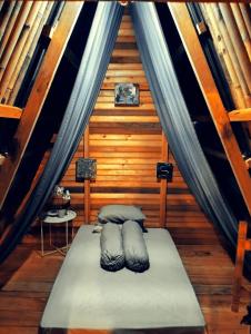 a bedroom with a bed in a wooden cabin at Sirus Base Camp Tagulandang in Kisihang +35 photos