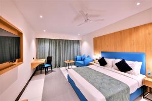 a hotel room with a bed and a flat screen tv at The Fern Residency, Subhash Bridge, Ahmedabad in Ahmedabad