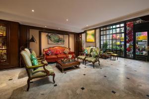 a living room with chairs and a couch and a table at San Grand Hotel & Spa in Hanoi