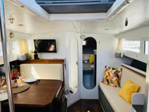 uma vista interior de uma caravana com uma mesa e um sofá em Falua em Barcelona