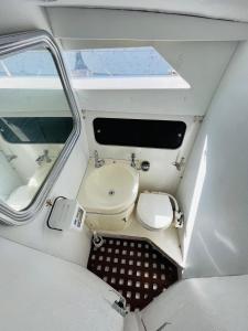 a small boat with a toilet and a sink at Falua in Barcelona