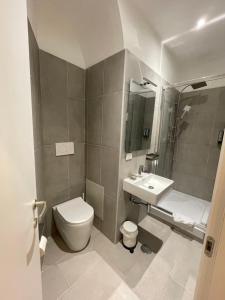 a bathroom with a toilet and a sink at The Room 15 in Rome +22 photos