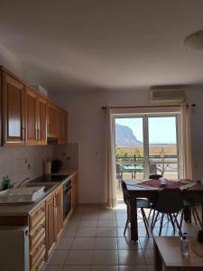 a kitchen with a table and a view of a mountain at Kanelli΄s apartments in Monemvasia