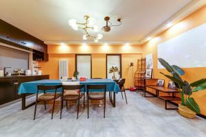 a dining room with a blue table and chairs at Banma Family All-Suite B&B in Xi'an