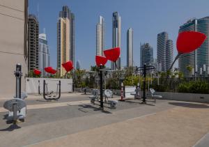 a row of exercise equipment in front of a city skyline at Bespoke Holiday Homes - Mag 318 Downtown Dubai in Dubai