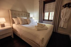 a bedroom with a bed with two towels on it at Jacobs Estate Cottage in Rowland Flat