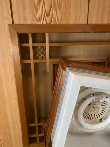 a stairwell in a wooden room with a spiral staircase at KIX House Waraku III 和楽三号館 in Izumi-Sano