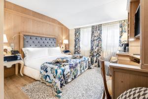 a hotel room with a bed and a television at Stikliai Hotel - Relais & Châteaux in Vilnius