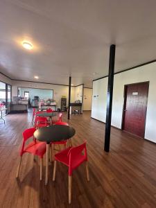 a room with red chairs and a table in a room at GEORGE ADVENTURE BASE BUNDU TUHAN 