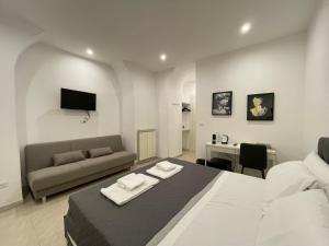 1 dormitorio con cama, sofá y escritorio en THE ROOM 115, en Roma