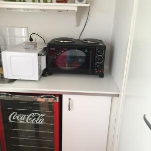 a microwave sitting on top of a kitchen counter at Peaceful Cottage in Gothenburg