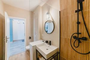 a bathroom with a white sink and a shower at Modern Studio near Old Town in Braşov +39 photos
