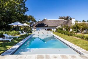 a swimming pool in the backyard of a house at Laborie Estate in Paarl