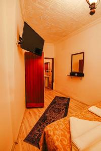 a living room with a red refrigerator and a television at Alaca Cave Suites in Goreme